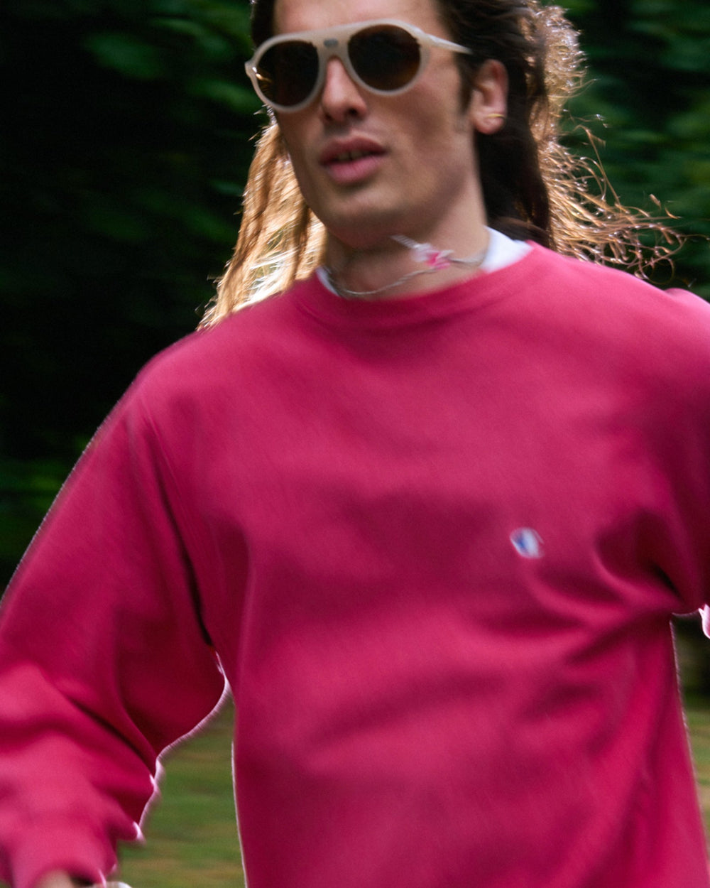 Amateur vintage washed pink Champion crewneck sweatshirt with small embroidered logo on chest and sleeve
