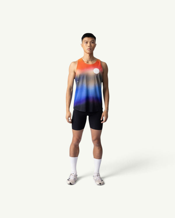 Amateur Dawn singlet featuring a sunrise gradient print on lightweight four-way stretch fabric worn by a male runner.
