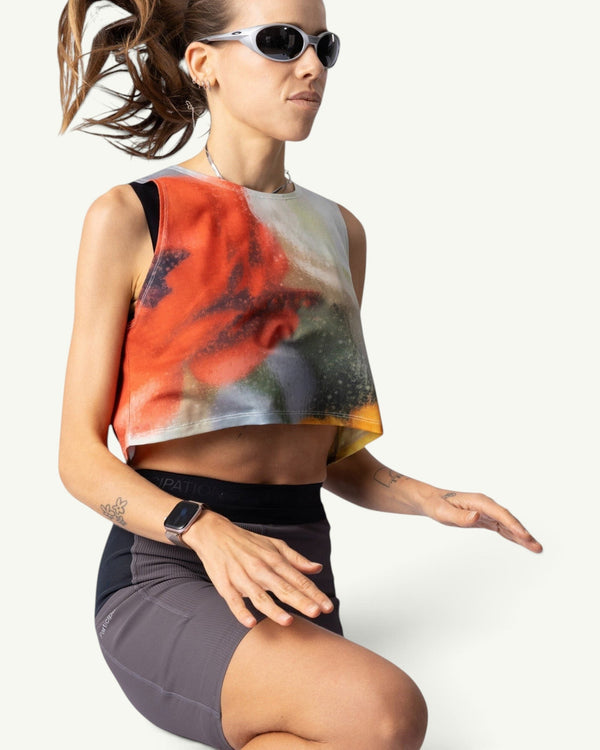 Amateur Frosted Glass crop singlet with abstract orange and grey print on a runner wearing sunglasses