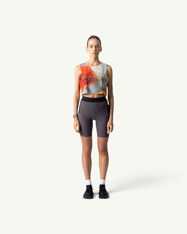 Amateur Frosted Glass crop singlet with abstract orange and grey print worn by a model with grey athletic shorts.