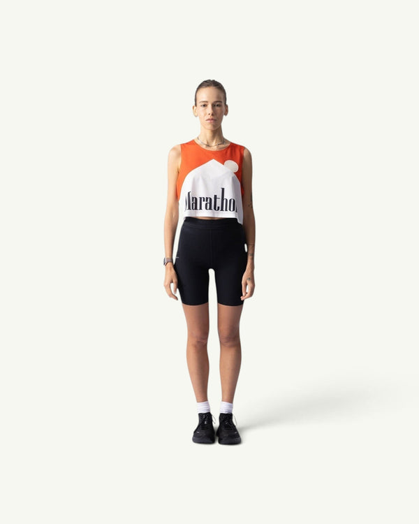 Participation Marathon Red crop singlet featuring a bold orange and white graphic print on a model against a plain background
