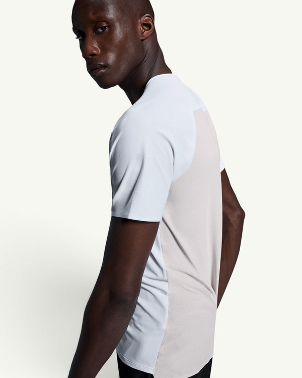 On men's performance running t-shirt in light blue and beige with technical moisture-wicking fabric