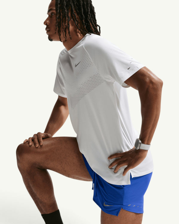 Amateur Nike men's blue Stride 5-inch brief-lined training shorts with reflective details on a runner