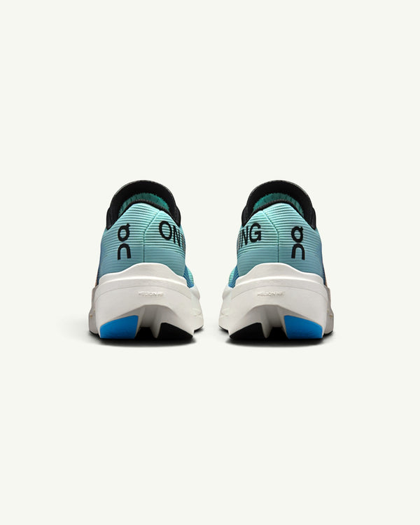 On Women's Cloudboom Volt racing shoes in light blue with white Helion HF foam soles, rear view.