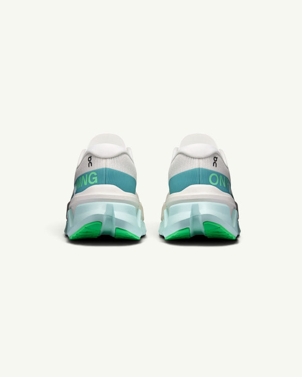 On Women's Cloudmonster 3 Hyper running shoes in white with teal and green accents, rear view