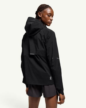 On women's black lightweight hooded windbreaker jacket for running, shown from the back.