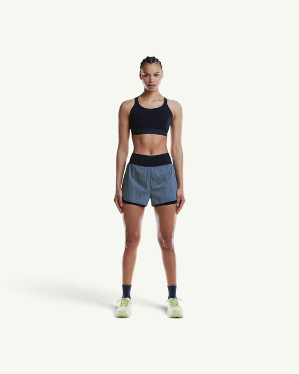 On model wearing a black performance sports bra with a chafe-free design and breathable stretch fabric.