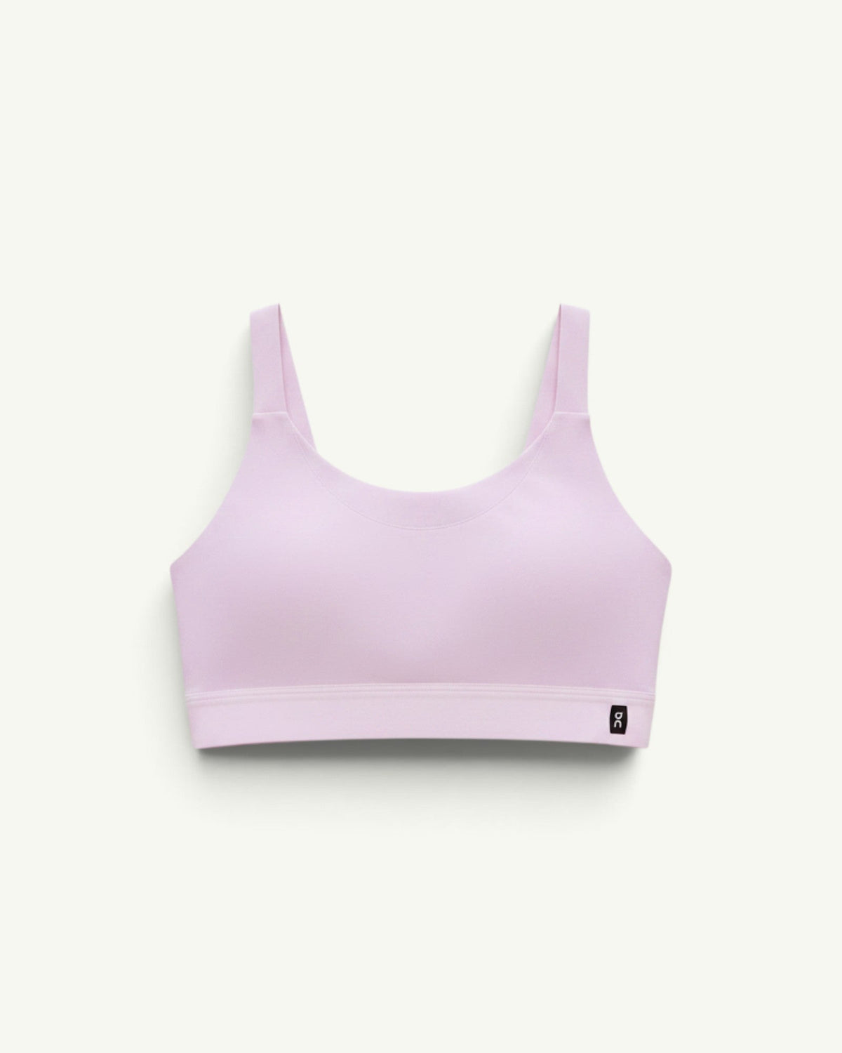 On women's performance bra in light pink with a chafe-free construction and breathable stretch fabric.