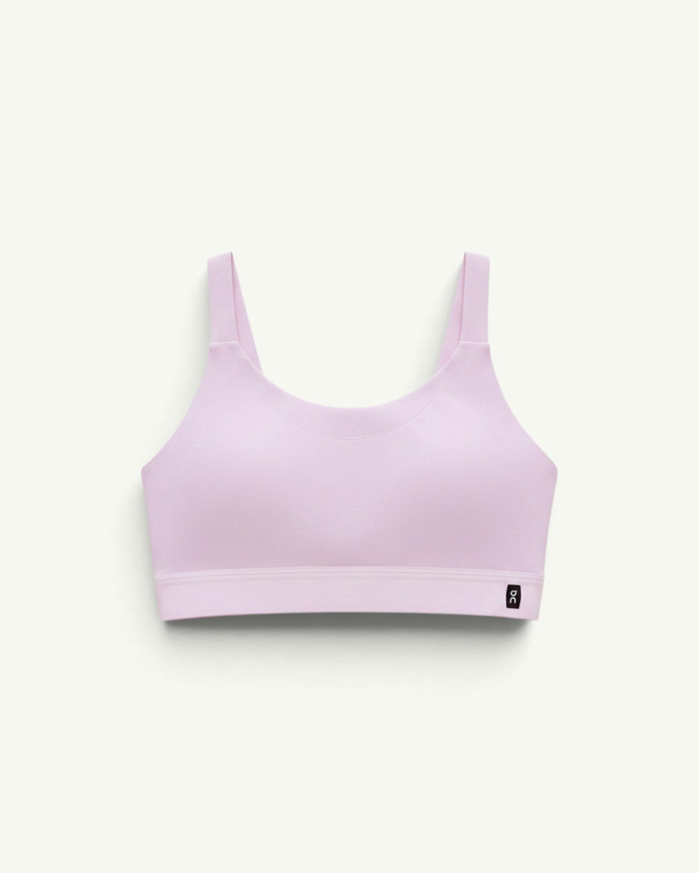 On women's performance bra in light pink with a chafe-free construction and breathable stretch fabric.