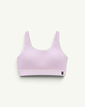 On women's performance bra in light pink with a chafe-free construction and breathable stretch fabric.