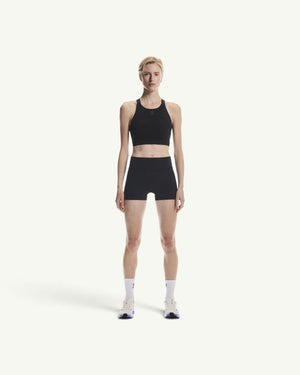On women's black performance crop top with a supportive, breathable design for running and training sessions.