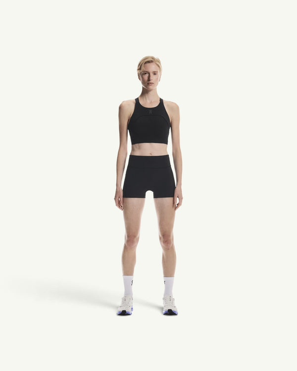 On women's black performance crop top with a supportive, breathable design for running and training sessions.