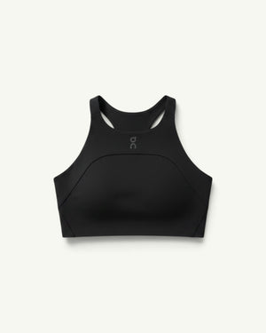 On women's black performance crop top with a high neckline and racerback design for running and training.