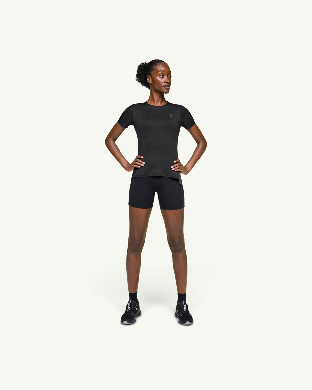 On women's black performance running t-shirt made from fast-drying technical fabric with a clean athletic cut.