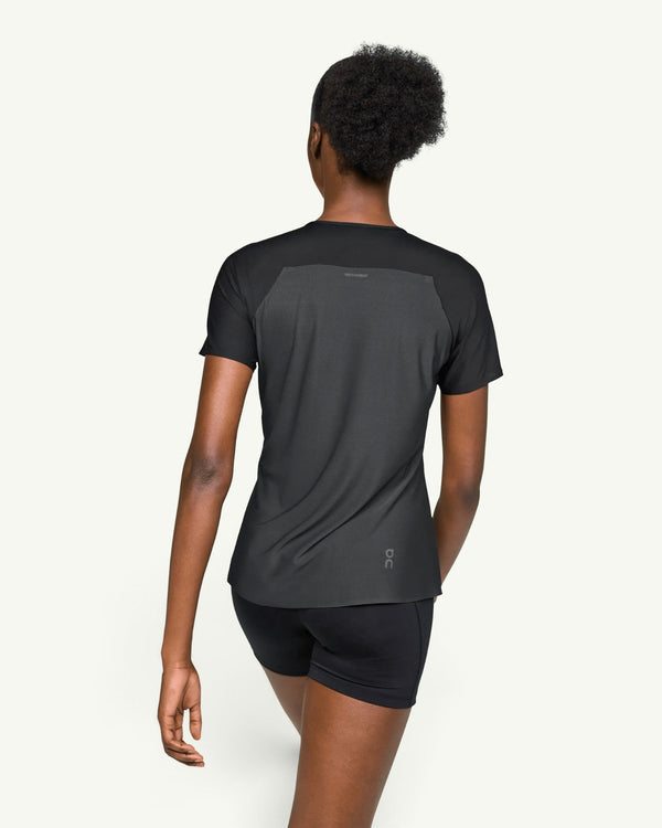 On women's black performance running t-shirt with technical fabric and back ventilation, rear view.