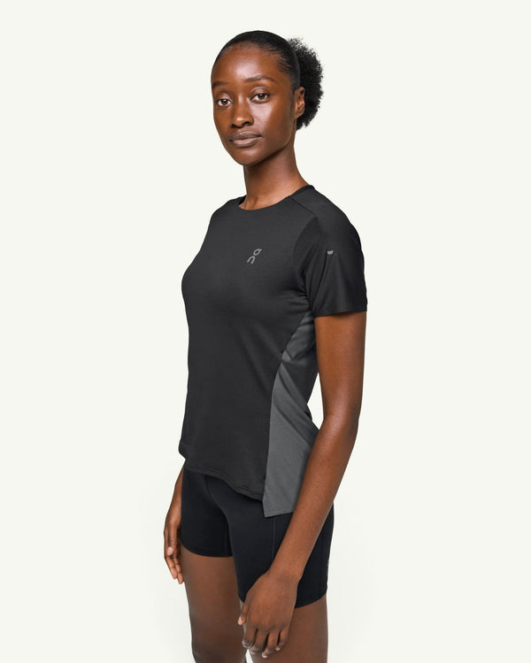 On women's black performance running t-shirt with technical fast-drying fabric and side ventilation panels.
