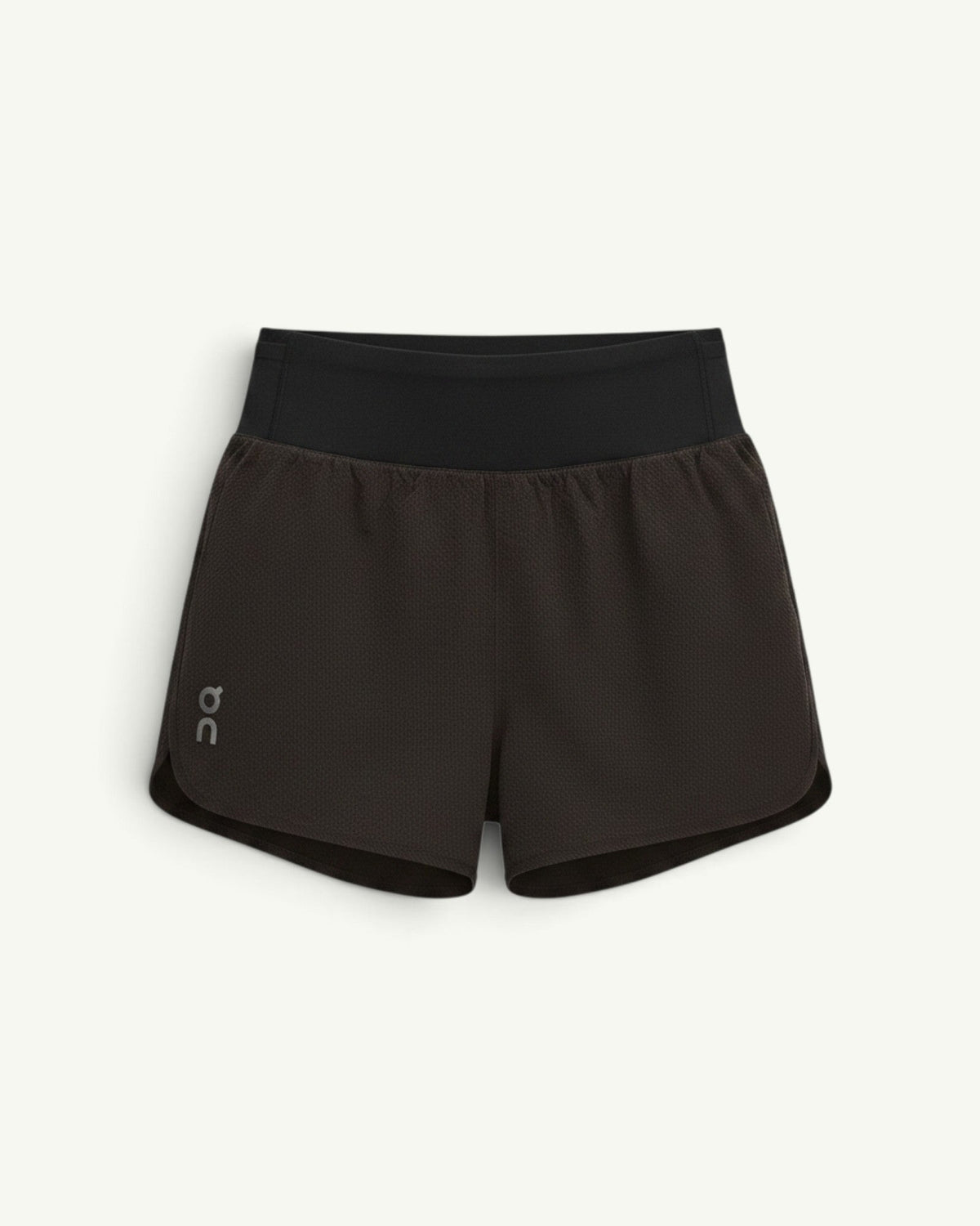 On women's performance volt running shorts in black with a high waistband and lightweight ventilated fabric.