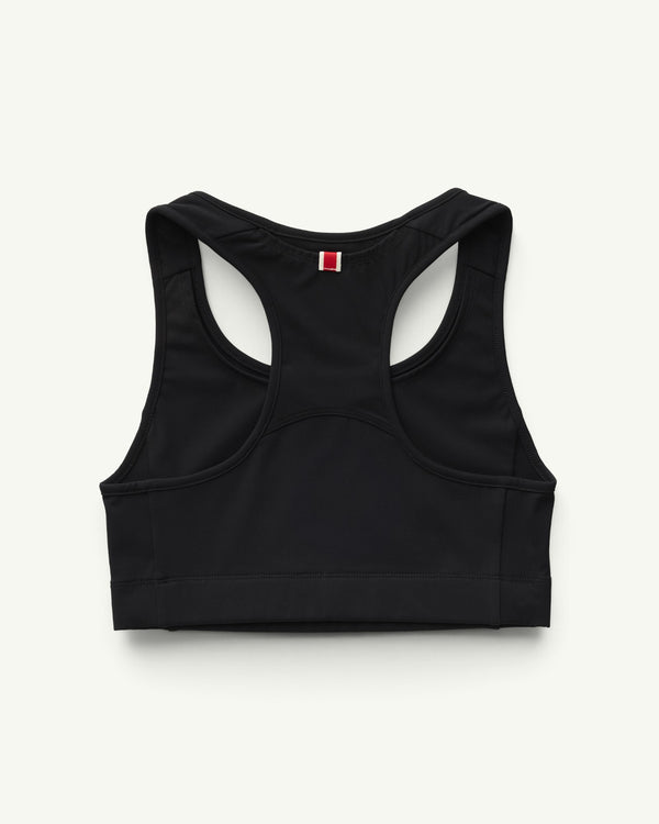 Amateur Women's Allston Bra in black, featuring a racerback design with a small red and white tab detail.