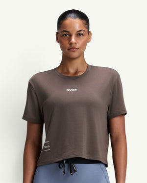 Amateur women's brown Micromesh cropped run tee with crew neck, boxy fit, and reflective branding on a model