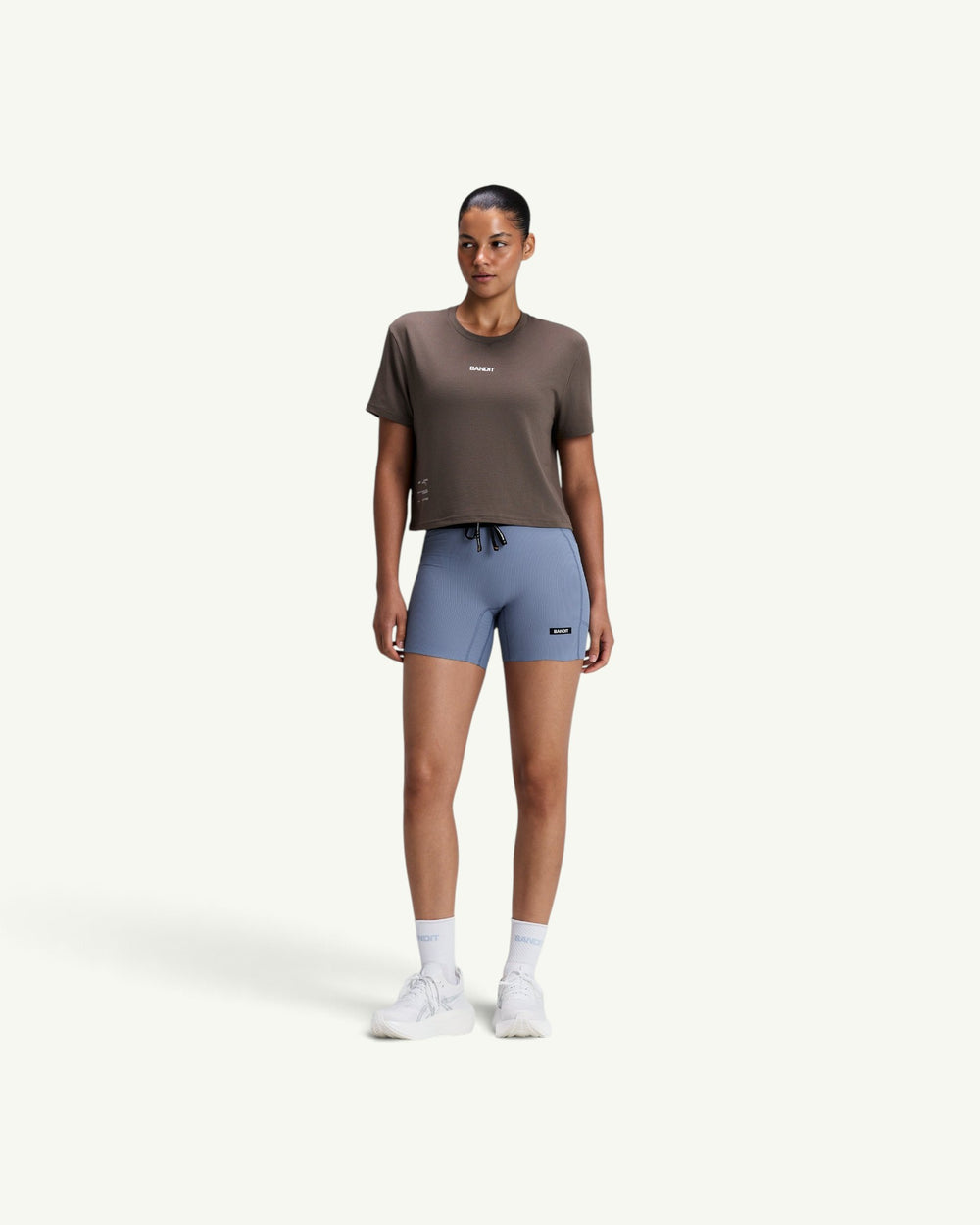 Amateur women's brown Micromesh cropped run tee with crew neckline and reflective branding details.