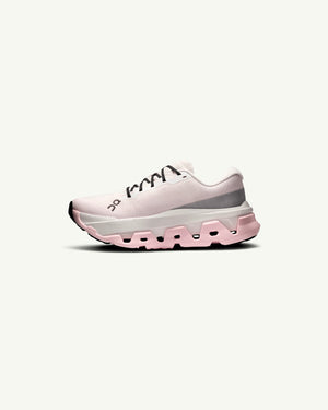Amateur women's Cloudmonster 3 Hyper running shoe in light pink with a thick cushioned sole and engineered mesh upper.