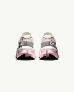 Amateur Women's Cloudmonster 3 Hyper running shoes in light pink and white with a bouncy CloudTec sole, rear view.