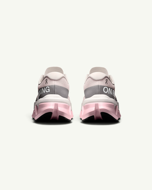 Amateur Women's Cloudmonster 3 Hyper running shoes in light pink and white with a bouncy CloudTec sole, rear view.