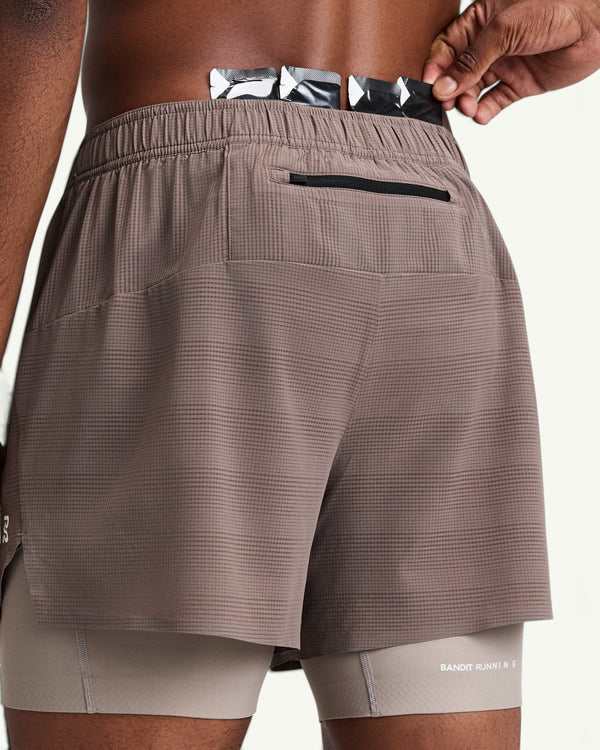 Amateur men's CoolGrid 2-in-1 running shorts in taupe with a back zipper pocket and integrated compression liner.