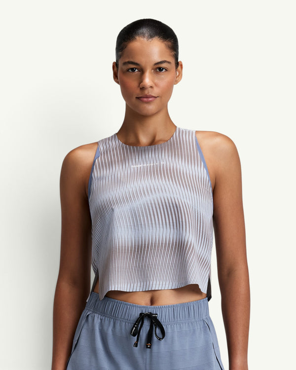 Amateur women's CoolGrid race singlet in light blue with sheer shadow-stripe knit, bonded seams, and side slits.