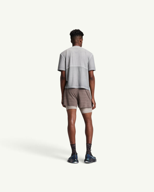 Amateur men's grey FrioSoft perforated box tee with back ventilation panels worn by a model from the back view.