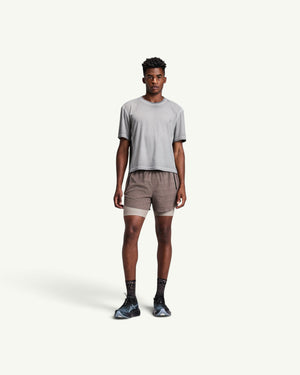 Amateur men's grey FrioSoft perforated boxy t-shirt worn by a model with athletic shorts and running shoes.