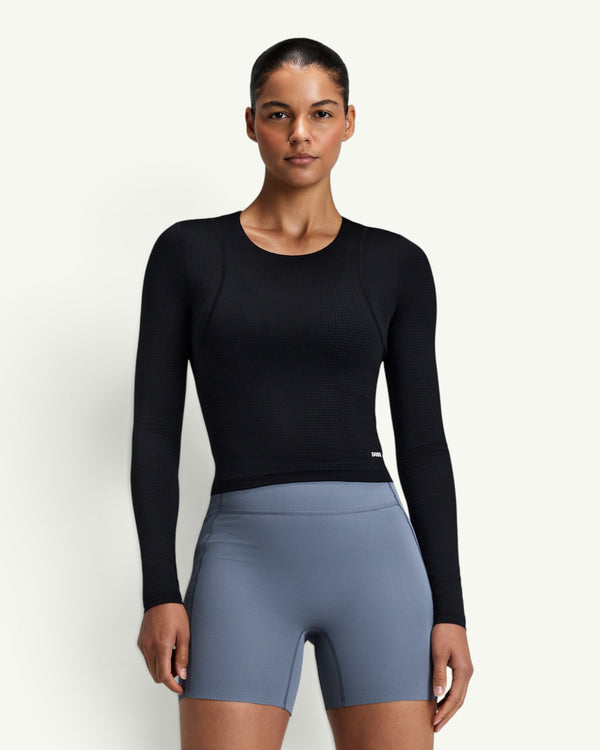 Amateur Women's GeoMesh Eclipse long sleeve performance top in black with a cropped fit and breathable knit texture.