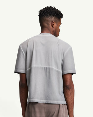 Back view of a man wearing an Amateur grey FrioSoft perforated box tee with a SaltFade finish.