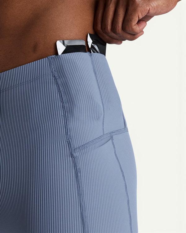 Amateur men's blue Gridlock quarter tights featuring a textured waffle-knit fabric and integrated gel storage pockets.