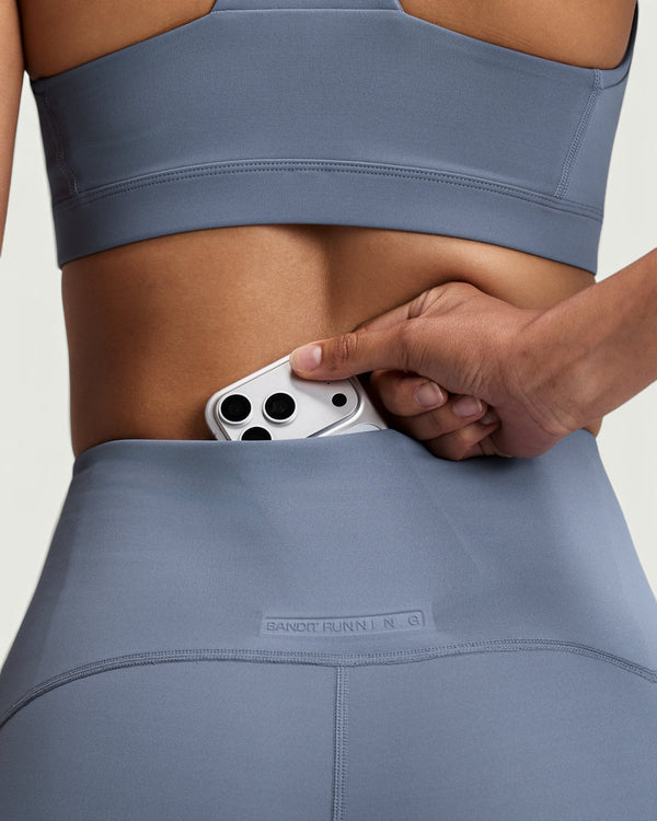 Amateur high-waist compression shorts in slate blue with a hidden centre-back phone pocket and embossed branding.