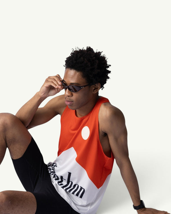 Amateur Marathon Red V2 unisex running singlet in red and white with signature print, worn by a male model.