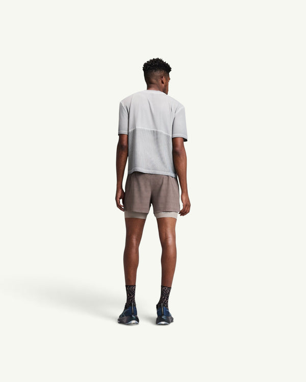 Amateur men's 2-in-1 CoolGrid running shorts in brown with integrated wicking liner, worn by a model from behind.