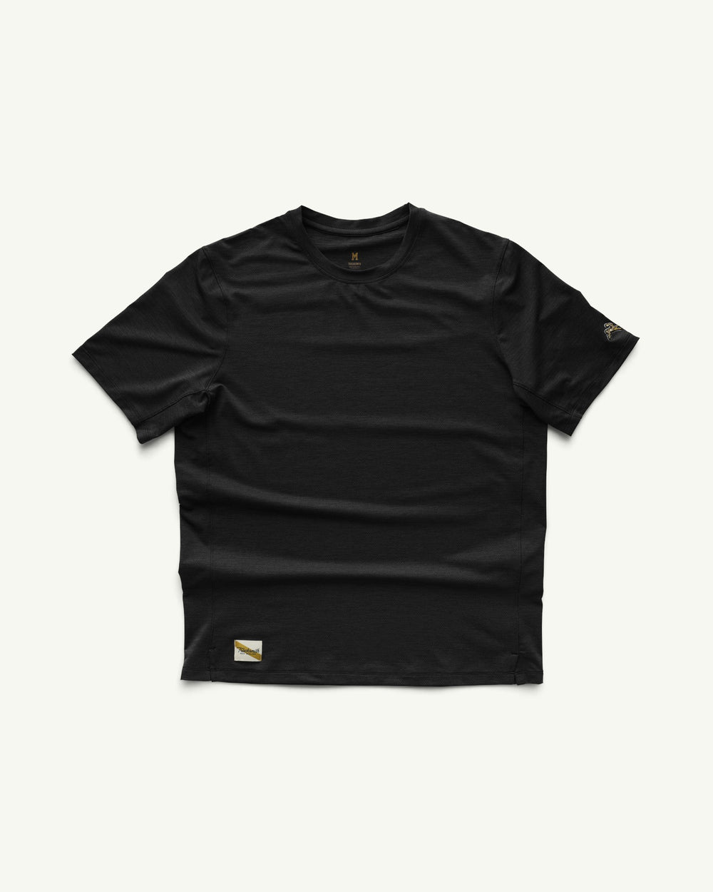 Amateur men's black moisture-wicking training t-shirt with short sleeves and a small brand patch on the hem.