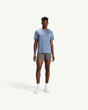 Amateur men's blue Micromesh run tee with crew neck, reflective details, and relaxed fit worn by a male model.