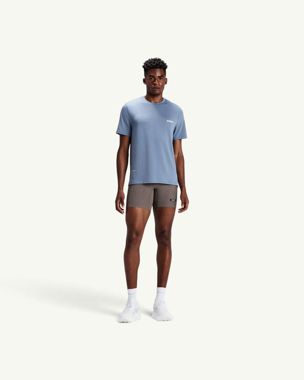 Amateur men's blue Micromesh run tee with crew neck, reflective details, and relaxed fit worn by a male model.