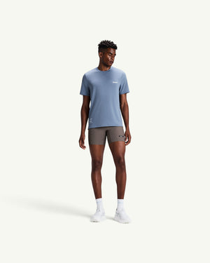 Amateur men's blue Micromesh run tee with crew neck and reflective details worn by a male model with athletic shorts