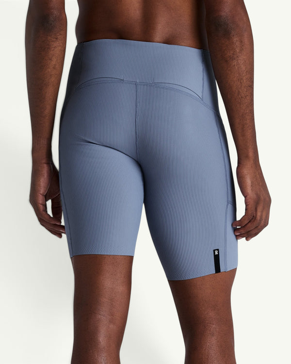 Amateur men's blue Gridlock quarter tights featuring a textured double-pique knit, compressive fit, and side pockets.