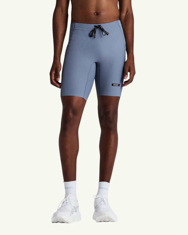 Amateur men's blue Gridlock quarter tights with compressive waffle-knit fabric, internal liner, and storage pockets.