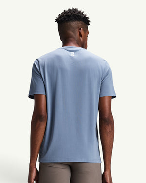Amateur Men's Micromesh run tee in light blue with a crew neckline and reflective logo detail on the back