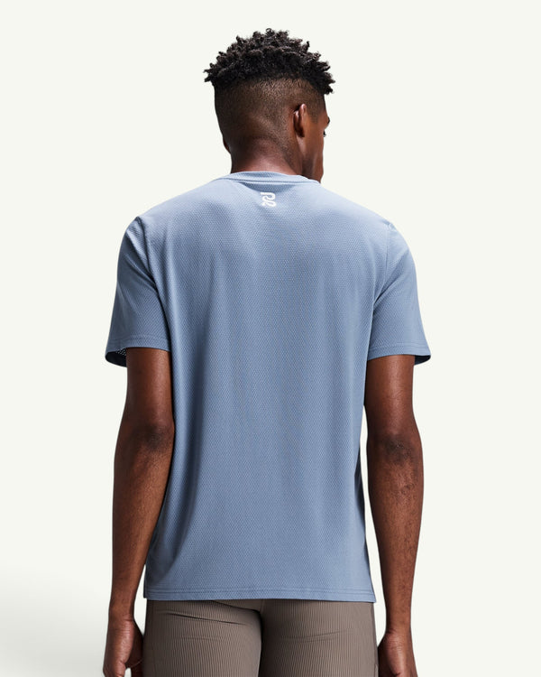 Amateur Men's Micromesh run tee in light blue with a crew neckline and reflective logo detail on the back