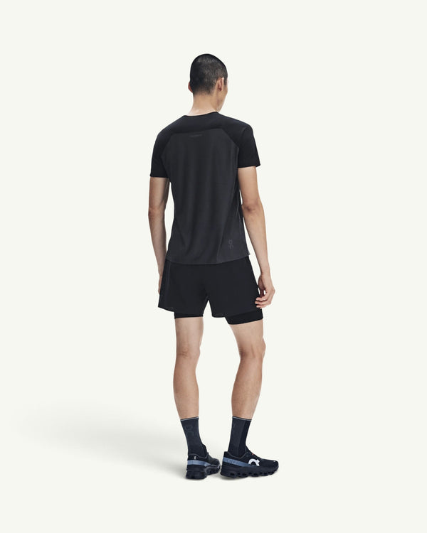 Amateur Men's Performance-T in black, a fast-drying technical running shirt worn by a man from a back view.