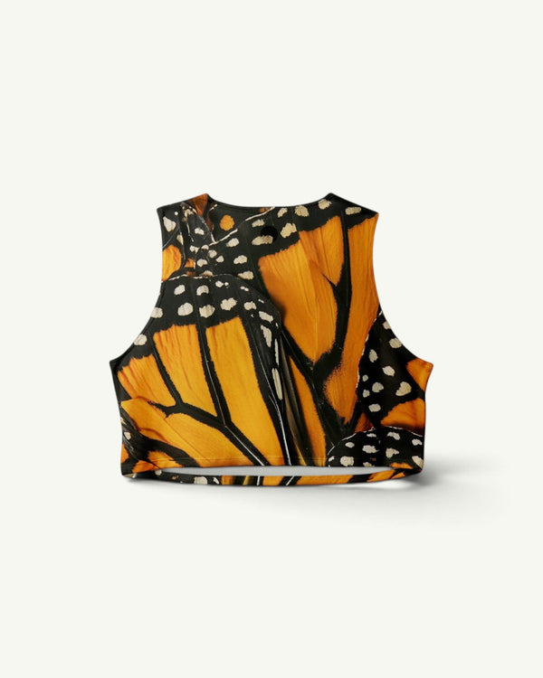 Participation Monarch crop singlet featuring a vibrant orange and black butterfly wing print in quick-drying stretch fabric.
