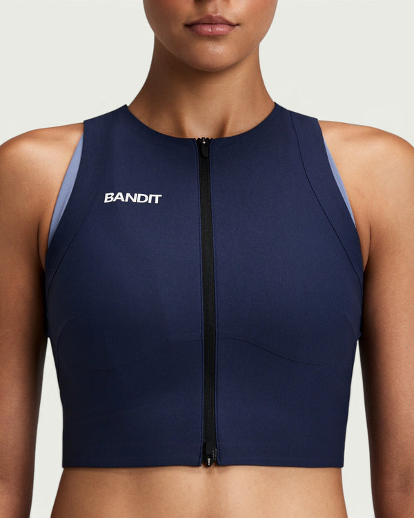 Amateur women's navy blue Adapto compression race crop top with a two-way front zipper and Bandit branding.