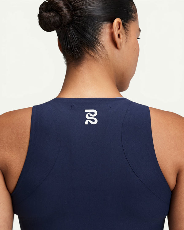 Amateur women's navy blue Adapto compression race crop top with back logo detail and lay-flat seams