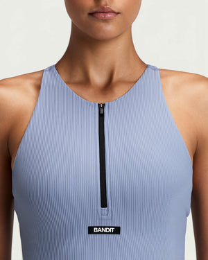 Amateur women's light blue ribbed zip-front race crop top with halter T-back design and built-in bra support